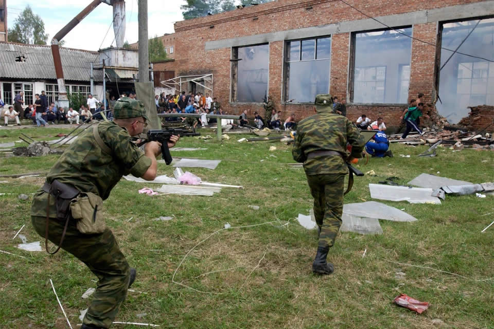 The military cover the fleeing hostages. Beslan