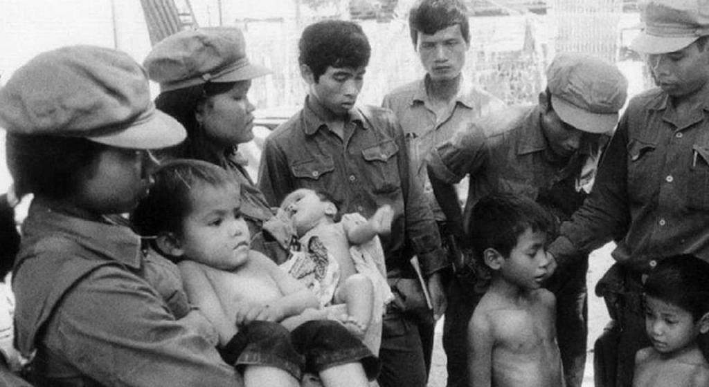 Vietnamese soldiers carrying surviving children from 'Prison S21'