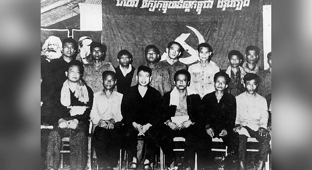Pol Pot with his associates against the backdrop of portraits of Karl Marx and Friedrich Engels