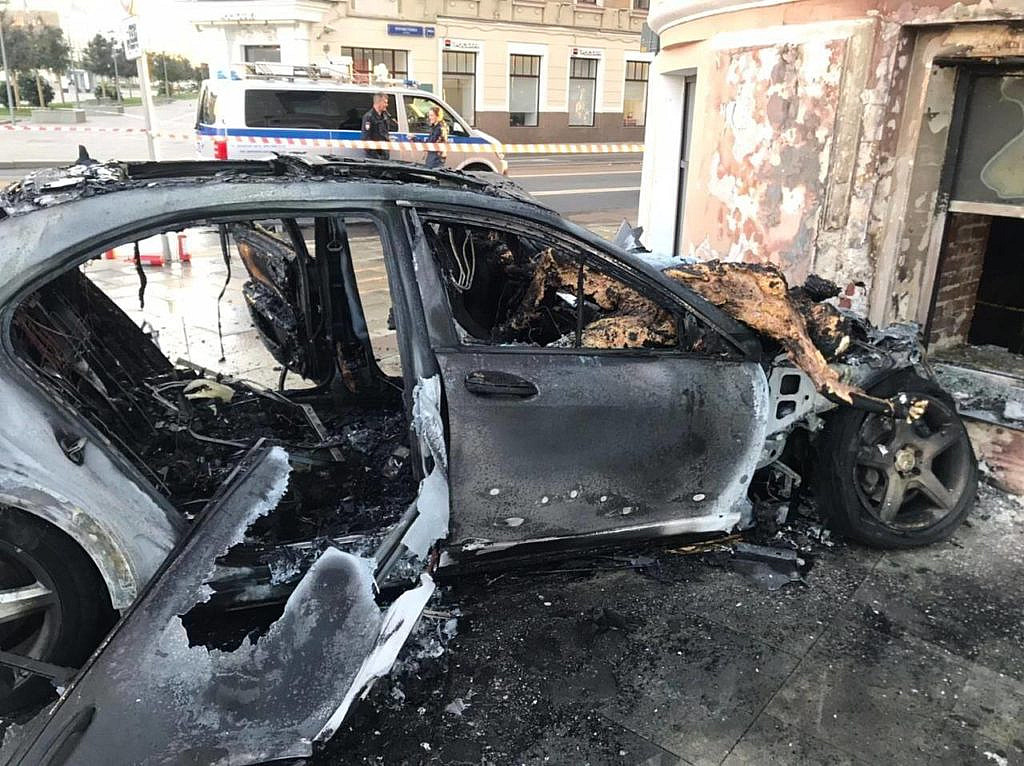 The car crashed into a wall and caught fire
