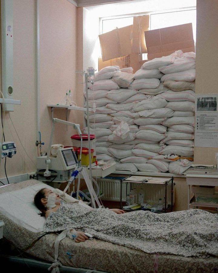 Ukraine. Wounded girl in the hospital. Windows covered with sandbags