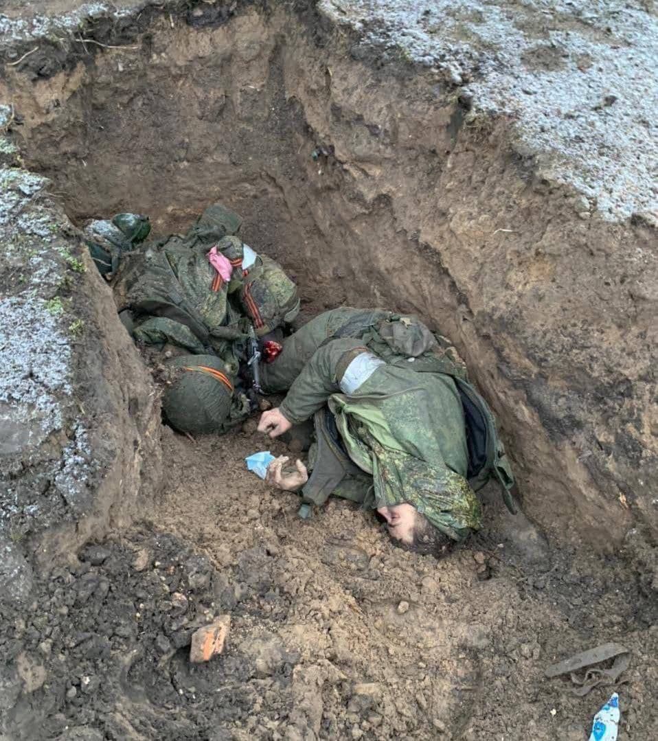 Corpses of Russian soldiers in a fresh grave
